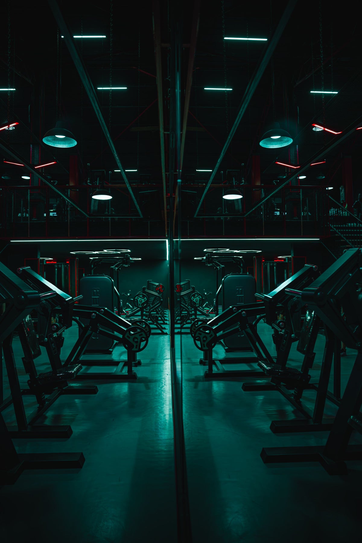 Dimly lit modern gym with equipment reflection